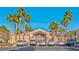 Community clubhouse with palm trees, parking, and desert landscaping at 700 Carnegie St # 4113, Henderson, NV 89052