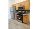 Kitchen with stainless steel appliances, wood cabinets, and tile flooring at 700 Carnegie St # 4113, Henderson, NV 89052