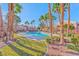 Community pool surrounded by mature palm trees and landscaping at 700 Carnegie St # 4113, Henderson, NV 89052