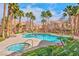 Community pool surrounded by lush landscaping and palm trees at 700 Carnegie St # 4113, Henderson, NV 89052