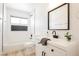 Modern bathroom featuring dark fixtures, subway tile, decorative accent tile, a shower, and updated sink at 716 Vincent Way, Las Vegas, NV 89145
