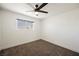 A bright and airy bedroom featuring neutral carpet, base molding and a window with outdoor views at 716 Vincent Way, Las Vegas, NV 89145