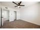 Bright bedroom with neutral carpet, base molding, a ceiling fan, and a sliding-door closet at 716 Vincent Way, Las Vegas, NV 89145