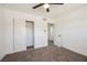 Bright bedroom with neutral carpet, base molding, a ceiling fan and a sliding-door closet at 716 Vincent Way, Las Vegas, NV 89145
