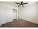 Bedroom with neutral carpet, base molding, a ceiling fan and a sliding-door closet at 716 Vincent Way, Las Vegas, NV 89145