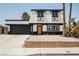 Charming two-story home with a modern black-and-white exterior, complemented by a well-maintained front yard at 716 Vincent Way, Las Vegas, NV 89145