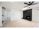 Bright living room featuring sleek flooring, a modern ceiling fan, and a stylish brick fireplace at 716 Vincent Way, Las Vegas, NV 89145