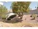 Backyard featuring easy care desert landscaping, mature trees, and partial grass at 7253 Alsop Ct, Las Vegas, NV 89156