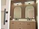 Modern bathroom with dual sinks, vanity, and sleek mirrors at 7253 Alsop Ct, Las Vegas, NV 89156