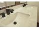 Modern bathroom featuring dual sinks, black faucets, and white countertop at 7253 Alsop Ct, Las Vegas, NV 89156