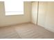 Bedroom featuring neutral carpeting, a window, and a closet at 7253 Alsop Ct, Las Vegas, NV 89156