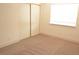 Bedroom features neutral carpeting, a window, and a closet at 7253 Alsop Ct, Las Vegas, NV 89156