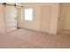 Spacious bedroom featuring sliding barn door and neutral carpeting at 7253 Alsop Ct, Las Vegas, NV 89156