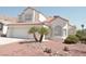 Charming two-story home featuring tile roof and two-car garage with desert landscaping at 7253 Alsop Ct, Las Vegas, NV 89156