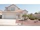 Charming two-story home with a tile roof, a two-car garage, and desert landscaping at 7253 Alsop Ct, Las Vegas, NV 89156