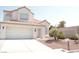 Charming two-story home with a tile roof, a two-car garage, and desert landscaping at 7253 Alsop Ct, Las Vegas, NV 89156