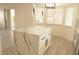 Bright kitchen featuring a quartz island, modern lighting and large windows at 7253 Alsop Ct, Las Vegas, NV 89156