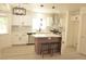 Modern kitchen with white cabinets, stainless steel appliances, and a center island at 7253 Alsop Ct, Las Vegas, NV 89156