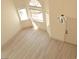 Bright living room with vaulted ceilings, three windows, and wood floors at 7253 Alsop Ct, Las Vegas, NV 89156