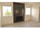 Living room featuring a modern black marble fireplace and large windows at 7253 Alsop Ct, Las Vegas, NV 89156