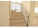 Staircase with wood stairs and modern black metal railing at 7253 Alsop Ct, Las Vegas, NV 89156