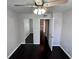 This bedroom features hardwood floors, a ceiling fan, and a closet with mirror doors at 8455 W Sahara Ave # 213, Las Vegas, NV 89117