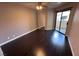 This bedroom has hardwood floors, a ceiling fan, and sliding glass door access to the patio at 8455 W Sahara Ave # 213, Las Vegas, NV 89117
