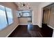 Open-concept dining room with modern lighting and hardwood flooring, adjacent to the kitchen at 8455 W Sahara Ave # 213, Las Vegas, NV 89117