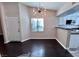 Open-concept dining room featuring hardwood floors, contemporary lighting, and access to the kitchen at 8455 W Sahara Ave # 213, Las Vegas, NV 89117