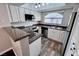 Well-lit kitchen featuring stainless steel appliances, granite countertops, and modern white cabinetry at 8455 W Sahara Ave # 213, Las Vegas, NV 89117