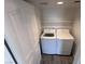 This laundry room contains a washer and dryer and some shelves at 8455 W Sahara Ave # 213, Las Vegas, NV 89117
