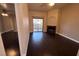 Bright living room showcasing dark hardwood floors, a cozy fireplace, and a sliding glass door to the patio at 8455 W Sahara Ave # 213, Las Vegas, NV 89117