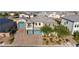 Spacious two-story home featuring a three-car garage, a balcony, landscaped yard, and a brick driveway at 8528 Baltimore Heights Ct, Las Vegas, NV 89113