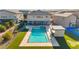 Aerial view showcases the pool and hot tub, poolside bar, sports court, and putting green at 8528 Baltimore Heights Ct, Las Vegas, NV 89113