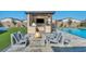 Outdoor kitchen and fire pit area perfect for entertaining with the pool and sport court nearby at 8528 Baltimore Heights Ct, Las Vegas, NV 89113