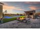 Backyard featuring a modern outdoor kitchen, fire pit, and sport court, ideal for entertaining at 8528 Baltimore Heights Ct, Las Vegas, NV 89113