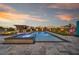 Stunning backyard with a large pool, spa, covered outdoor kitchen, and a spacious patio area, perfect for entertaining at 8528 Baltimore Heights Ct, Las Vegas, NV 89113