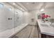 Bright bathroom featuring a glass enclosed shower and dual vanities with floral accent at 8528 Baltimore Heights Ct, Las Vegas, NV 89113