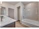 Bright bathroom features a tiled shower and a soaking tub at 8528 Baltimore Heights Ct, Las Vegas, NV 89113