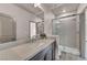 Bathroom featuring toilet and glass enclosed shower, next to countertop sink at 8528 Baltimore Heights Ct, Las Vegas, NV 89113