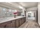 Bathroom with double sinks, wood cabinetry and large glass enclosed shower at 8528 Baltimore Heights Ct, Las Vegas, NV 89113