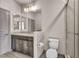 Bathroom featuring glass enclosed shower and toilet next to sink with dark wood cabinets at 8528 Baltimore Heights Ct, Las Vegas, NV 89113