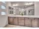 Elegant bathroom featuring double sinks, spacious countertop and an oversized mirror at 8528 Baltimore Heights Ct, Las Vegas, NV 89113