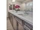 Close-up of bathroom featuring double sinks, white countertops and dark wood cabinets at 8528 Baltimore Heights Ct, Las Vegas, NV 89113