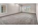 Spacious bedroom with neutral carpet, baseboards and natural light from multiple windows at 8528 Baltimore Heights Ct, Las Vegas, NV 89113