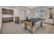 Upstairs game room with a pool table, built in cabinets, and natural light, perfect for entertaining friends and Gathering at 8528 Baltimore Heights Ct, Las Vegas, NV 89113