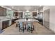 Beautiful kitchen featuring dark wood cabinets, stainless steel appliances, and a large white island with seating at 8528 Baltimore Heights Ct, Las Vegas, NV 89113