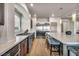The kitchen features a large island, stainless steel appliances, and wood flooring at 8528 Baltimore Heights Ct, Las Vegas, NV 89113