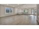 Large living room with gray wood-look tile, lots of windows and a large sectional sofa at 8528 Baltimore Heights Ct, Las Vegas, NV 89113