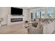 Bright living room with a modern fireplace, large windows, and a comfortable gray sofa, perfect for relaxing at 8528 Baltimore Heights Ct, Las Vegas, NV 89113